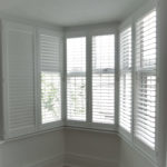 White lounge bay window with shutters half open