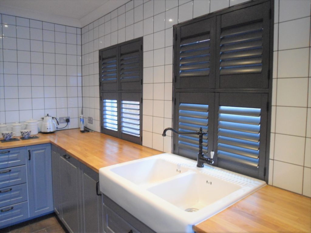 black kitchen shutters with oak worktops