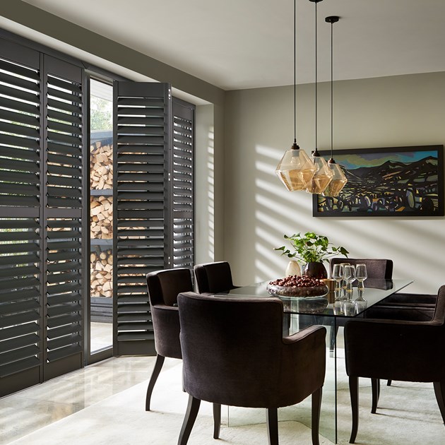 black full height shutters in dramatic dining area