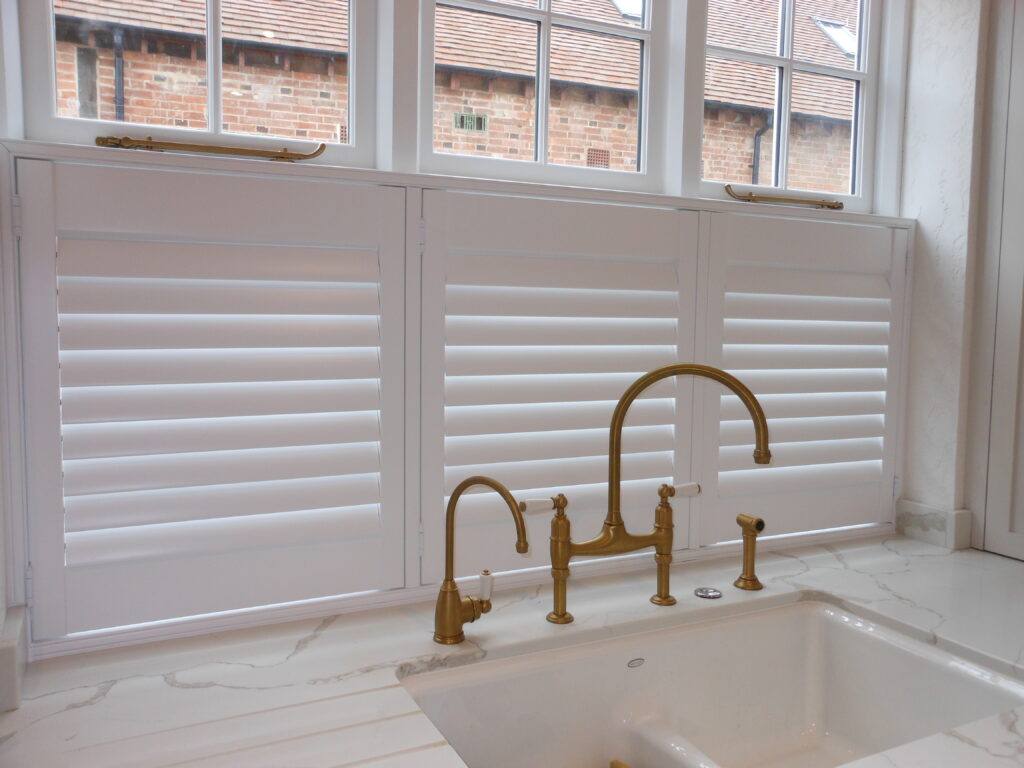 Brass taps in front of a white cafe shutter