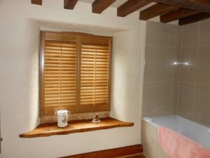 Traditional oak shutters in a bathroom