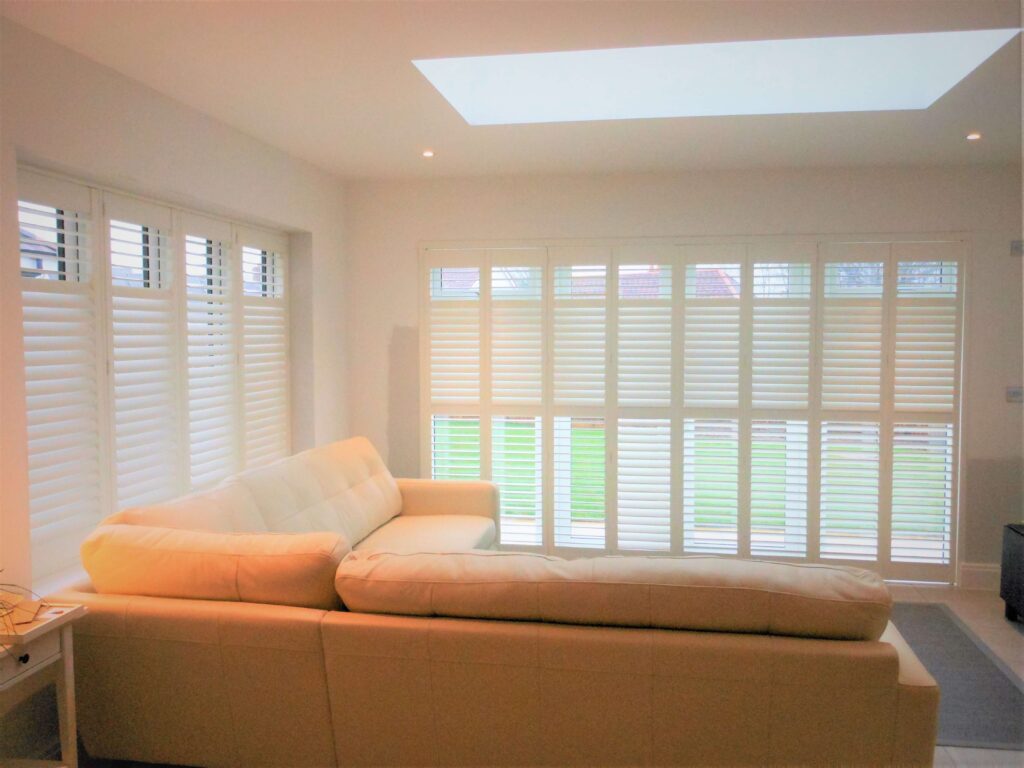 full height patio door shutters in a conservatory