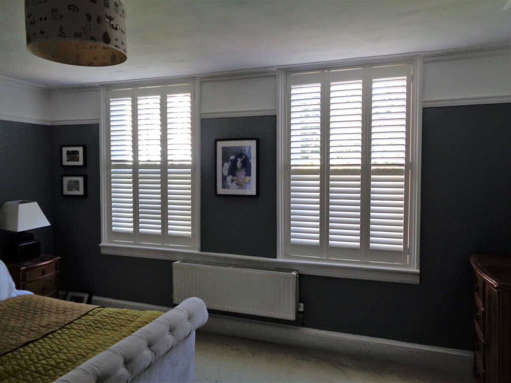 navy bedroom with white shutters