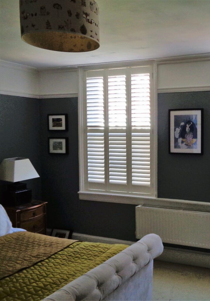 bedroom with full height shutters in white - closed